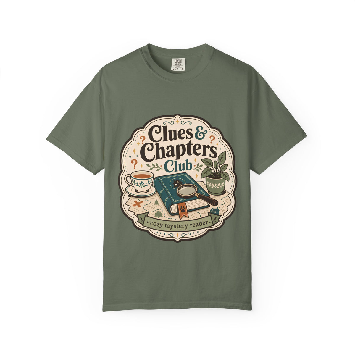 Clues and Chapters Club cozy mystery reader T-shirt with book, magnifying glass, tea cup, map and botanical details on Moss.
