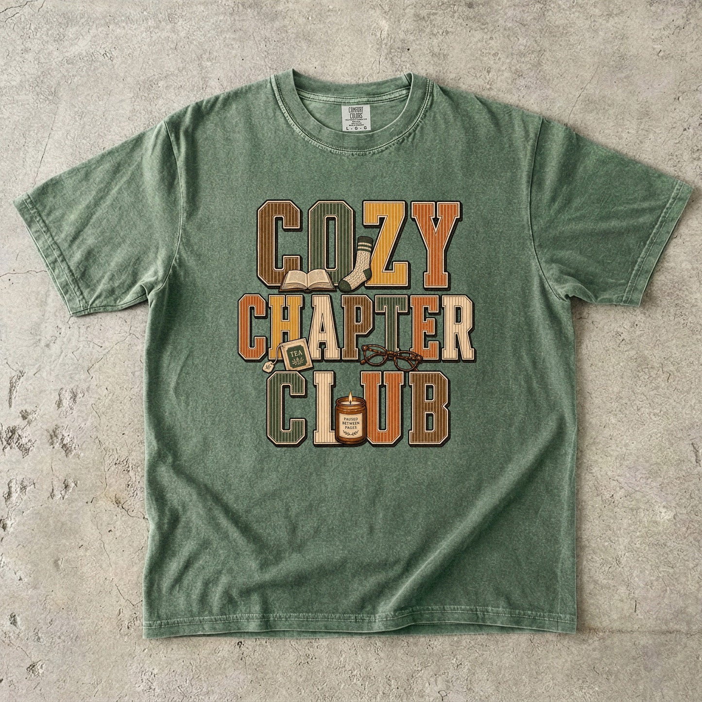 Moss Comfort Colors Cozy Chapter Club bookish T-shirt with warm vintage typography and reading-inspired details.