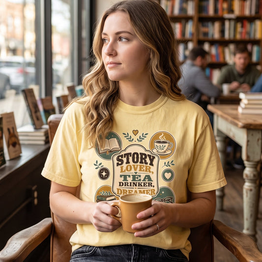 Story Lover Tea Drinker Dreamer shirt in Moss styled in a cozy books and tea lifestyle setting for readers.