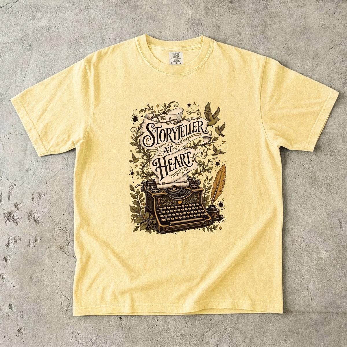 Storyteller at Heart writer shirt in Butter with vintage typewriter and literary illustration for writers and storytellers.
