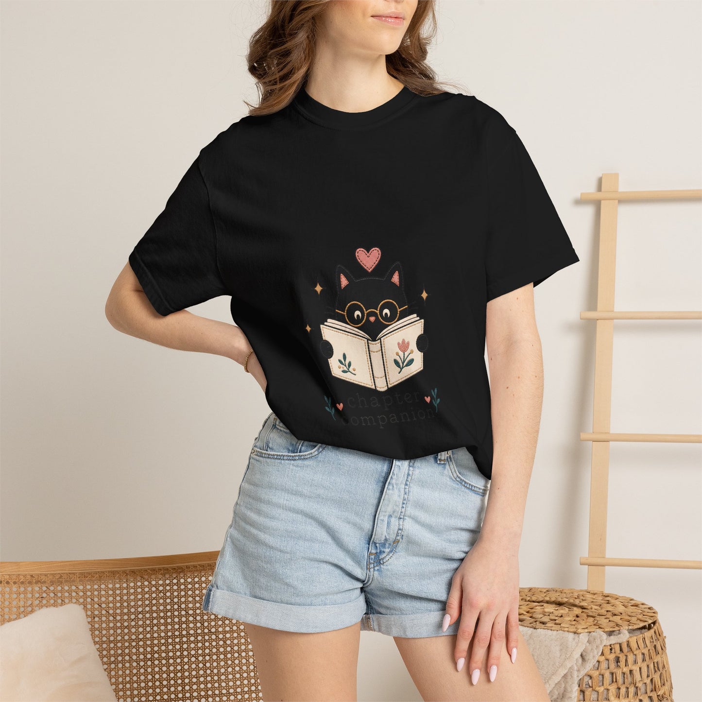 Woman wearing the black Chapter Companion book lover cat T-shirt by Flourish Creation Labs, a premium reading-inspired graphic tee.