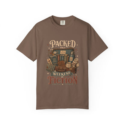 Packed for a Weekend in Fiction reading T-shirt in Espresso featuring a vintage suitcase packed with books, a mug, thermos and cozy socks