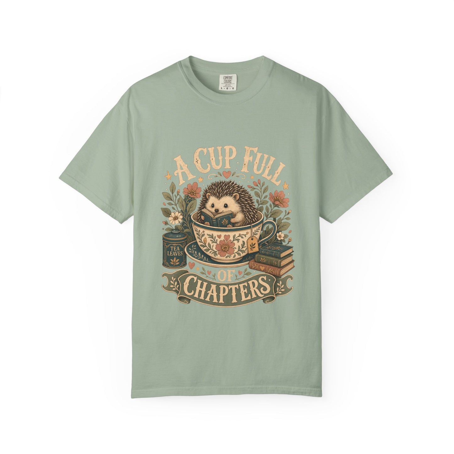 Front view of the A Cup Full of Chapters Book Lover Shirt on a Comfort Colors 1717 garment-dyed T-shirt in Bay featuring a cosy hedgehog, books and tea-inspired artwork.