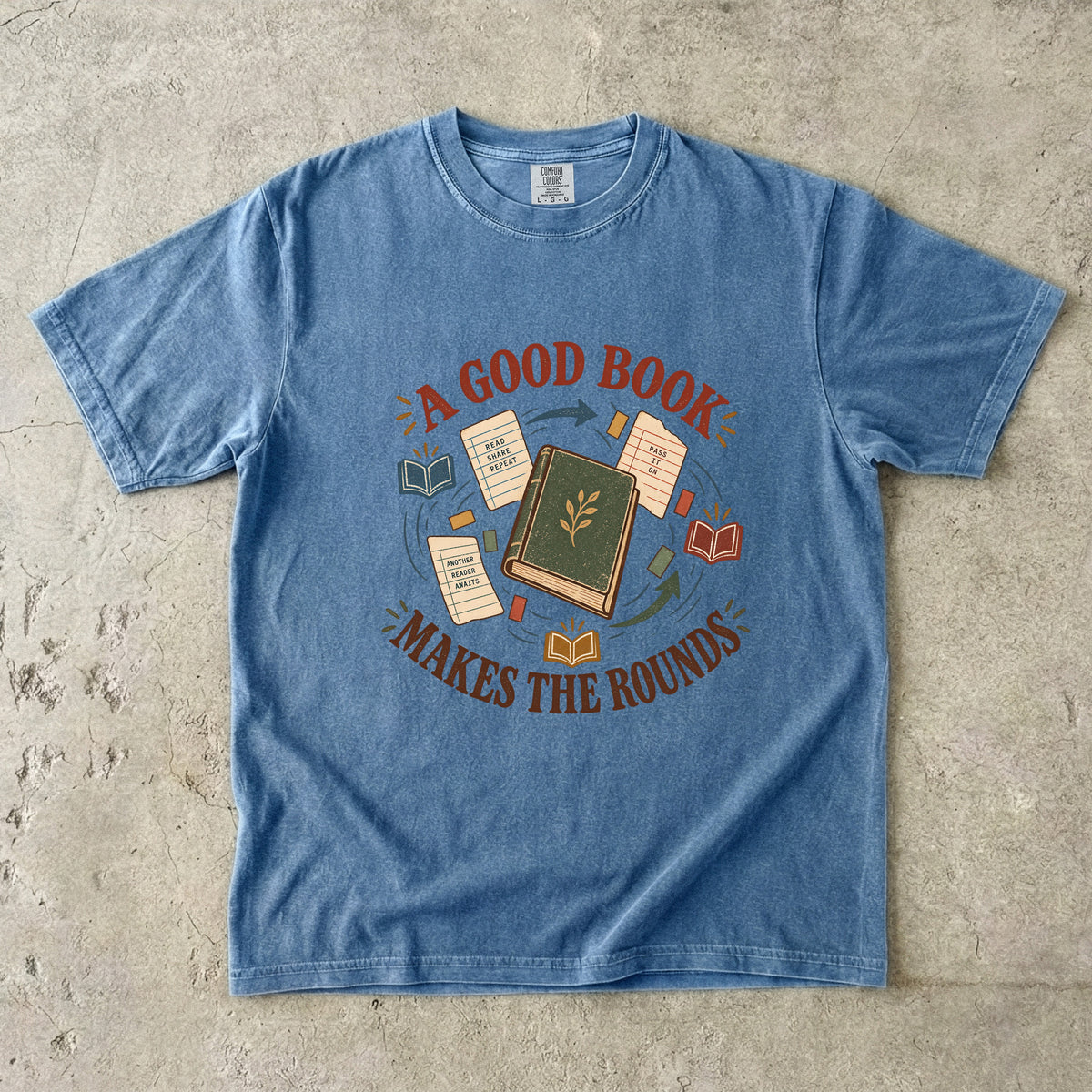 Blue Jean book lover T-shirt with “A Good Book Makes the Rounds,” a book, arrows and sharing notes