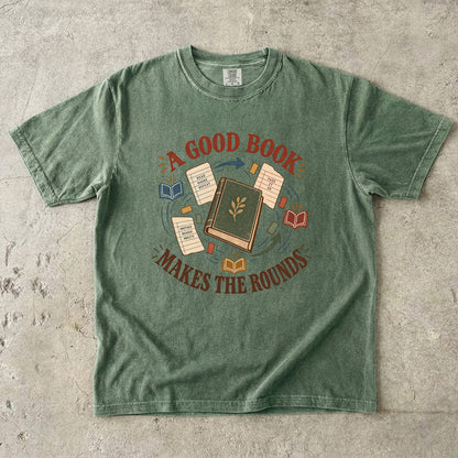 Moss book lover T-shirt with “A Good Book Makes the Rounds,” a book, arrows and sharing notes