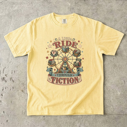 Front view of a Butter 
Comfort Colors graphic T-shirt featuring the vintage "A Little Ride Through Fiction" book lover artwork celebrating the joy of reading.