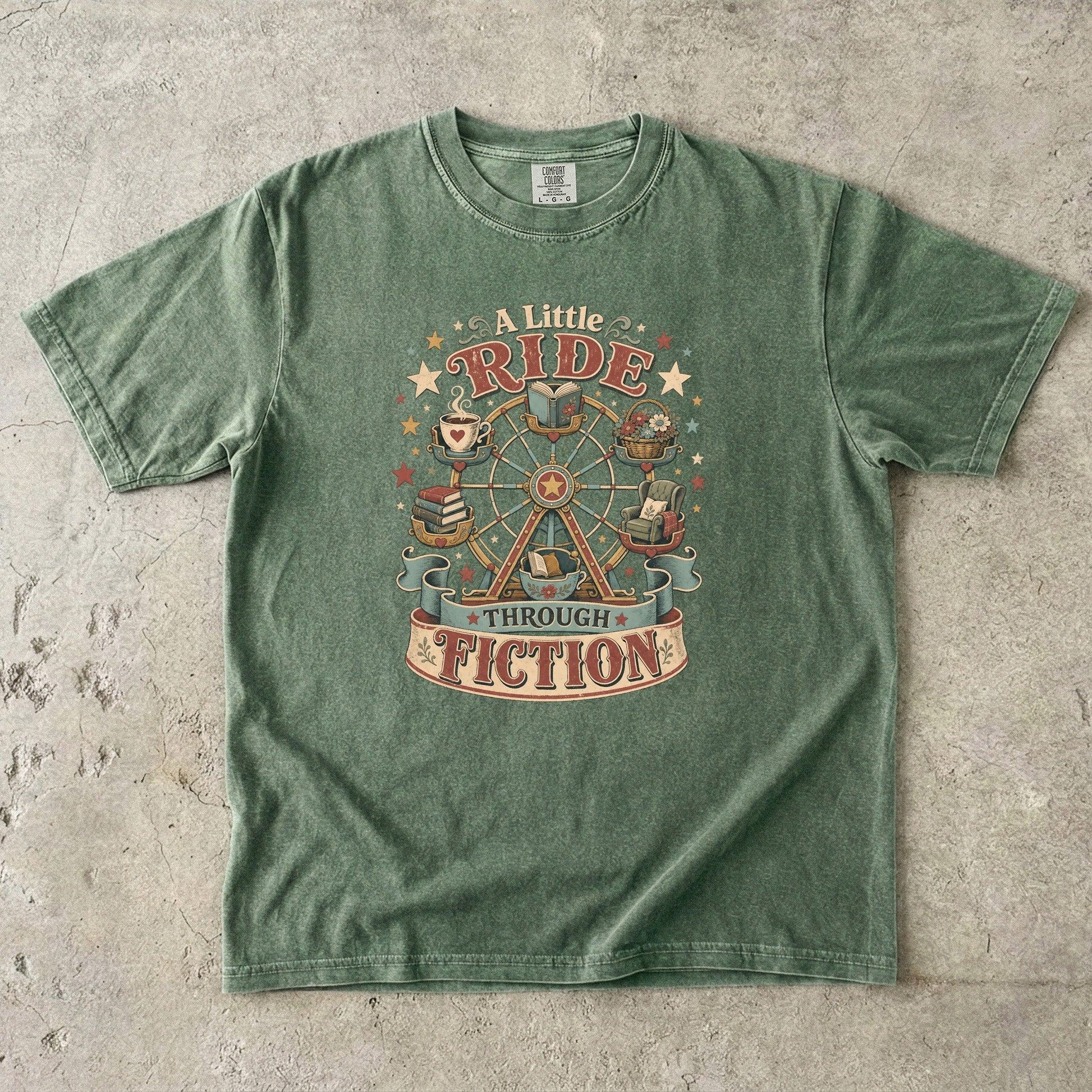 Front view of a Moss Comfort Colors book lover T-shirt featuring the "A Little Ride Through Fiction" design with books, tea, flowers and a whimsical Ferris wheel.