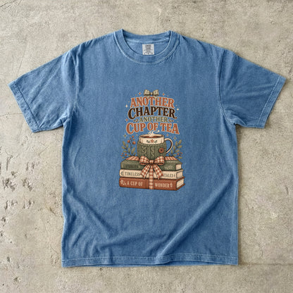 Another Chapter Another Cup of Tea reading shirt in Blue Jean with vintage books, teacup and cozy reading artwork.
