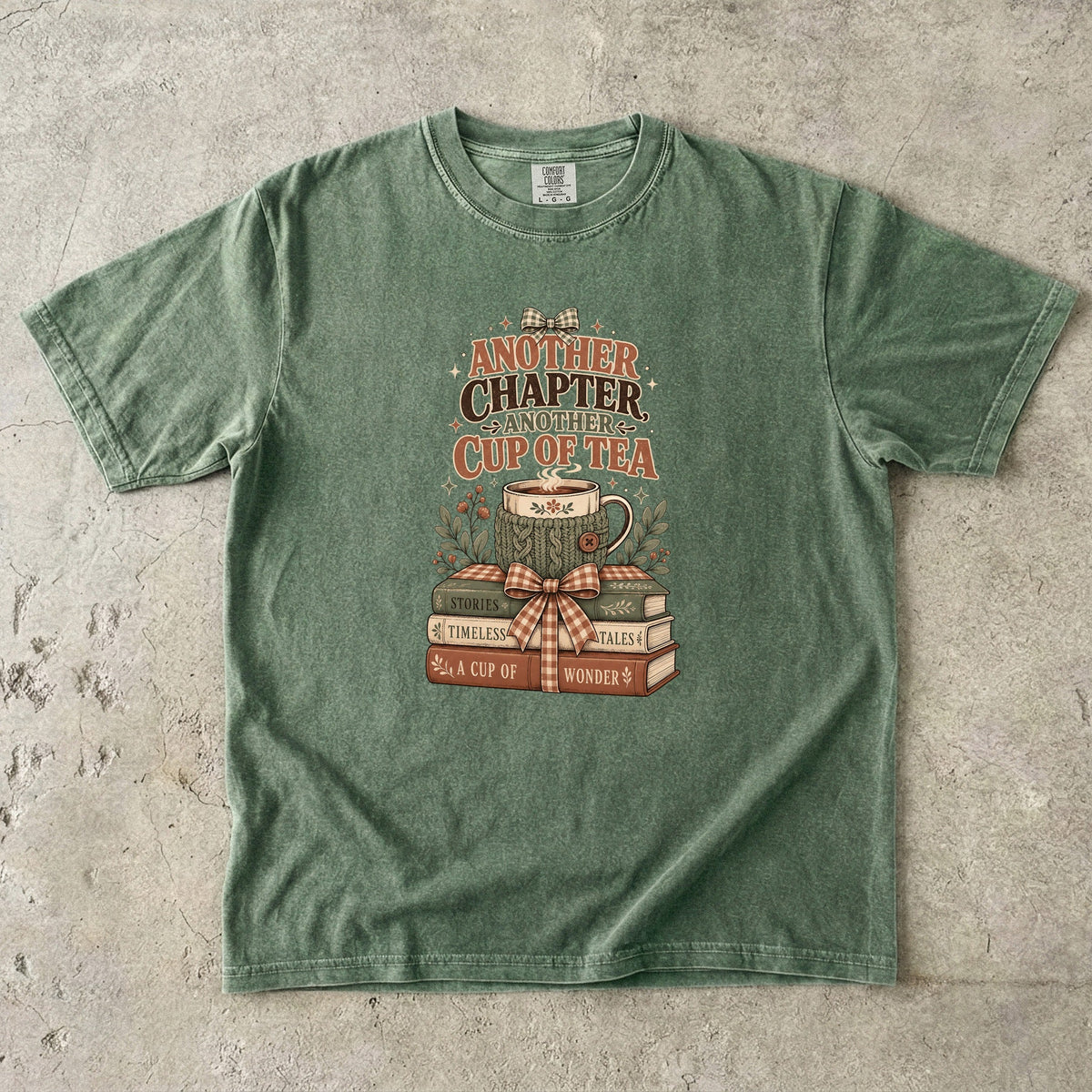 Another Chapter Another Cup of Tea reading shirt in Moss featuring a cozy teacup, vintage books and gingham bow.