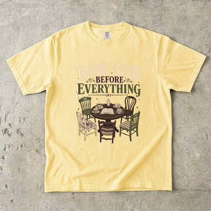 Butter book club T-shirt featuring Book Club Before Everything with a vintage table, open book, teacups, candle and mismatched chairs.