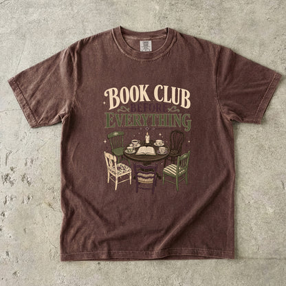 Espresso book club T-shirt featuring Book Club Before Everything with a vintage table, open book, teacups, candle and mismatched chairs.