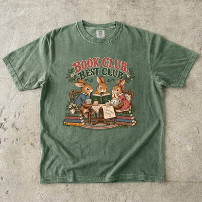 Moss T-shirt featuring “Book Club, Best Club” with three rabbits reading together at a tea table, floral china, books and daisies.