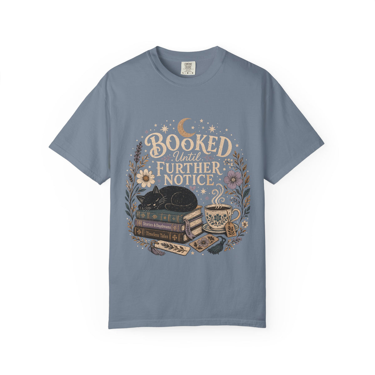 Booked Until Further Notice cat reading T-shirt with sleeping black cat, stacked books, teacup and flowers on Blue Jean.
