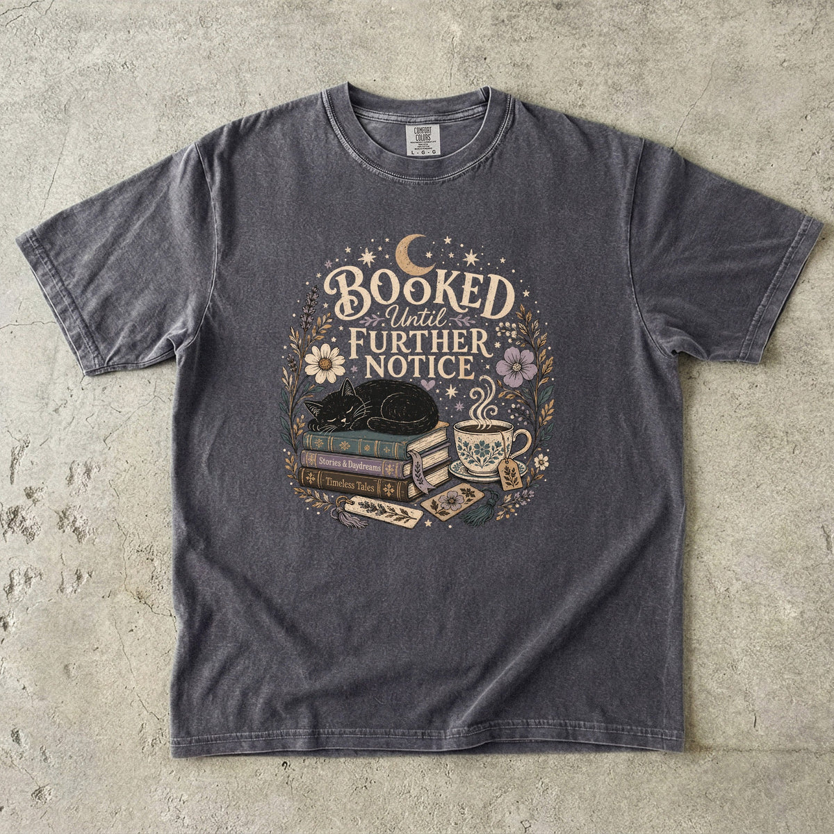 Booked Until Further Notice cat reading T-shirt with sleeping black cat, stacked books, teacup and flowers on Pepper.