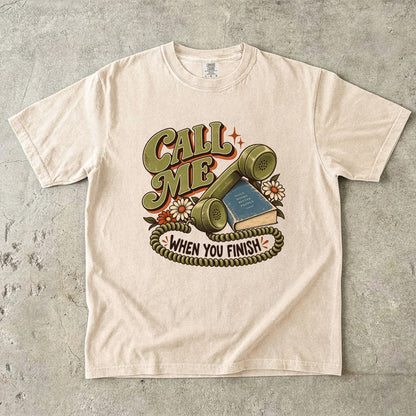 Ivory book lover T-shirt with “Call Me When You Finish,” a retro telephone, book and flowers