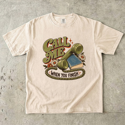 Ivory book lover T-shirt with “Call Me When You Finish,” a retro telephone, book and flowers