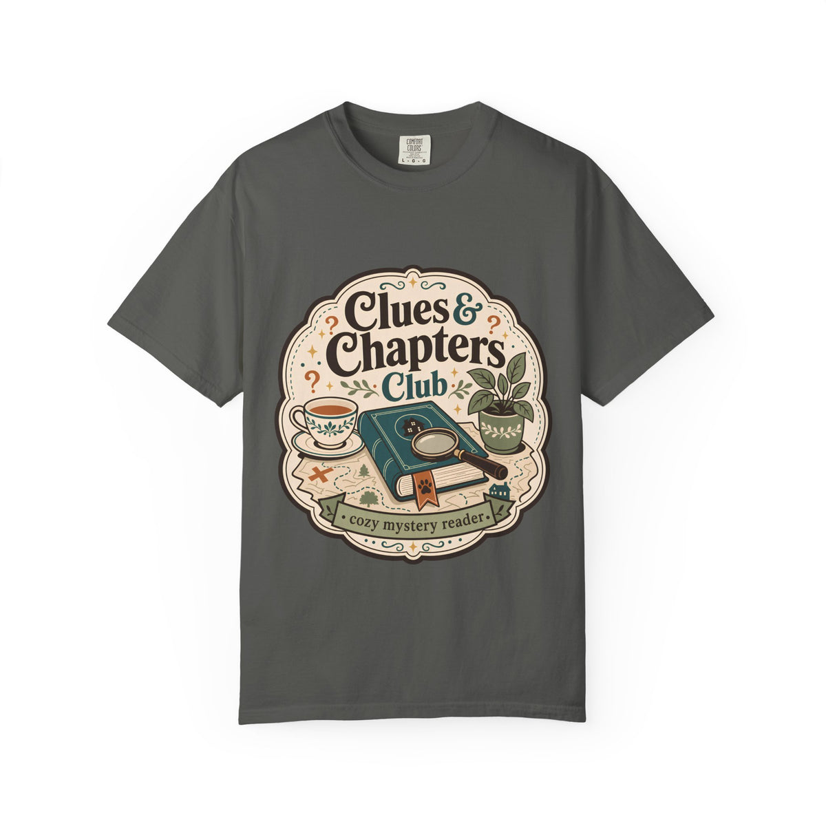 Clues and Chapters Club cozy mystery reader T-shirt with book, magnifying glass, tea cup, map and botanical details on Pepper.
