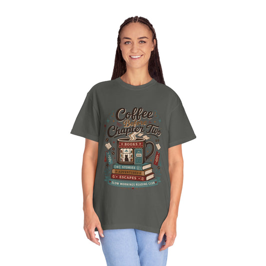 Woman wearing the Coffee Before Chapter Two Pepper Comfort Colors coffee lover and book lover T-shirt featuring a cozy bookstore and coffee illustration.