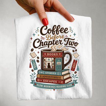 Close-up handheld view of the Coffee Before Chapter Two White Comfort Colors coffee lover and book lover T-shirt showing the detailed bookstore artwork.