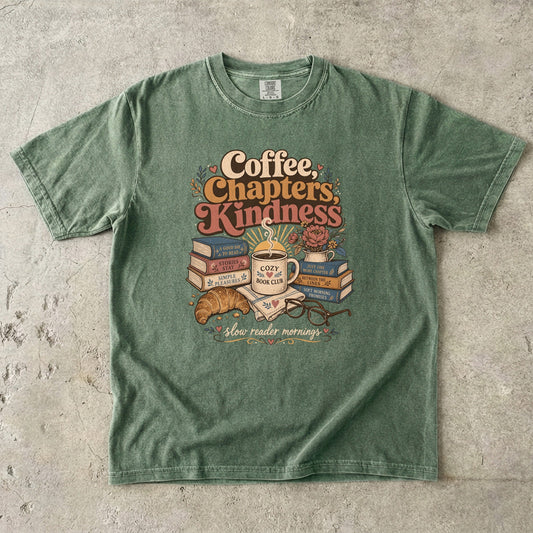 Coffee, Chapters, Kindness cozy reader T-shirt with coffee, books and croissant design on Moss.