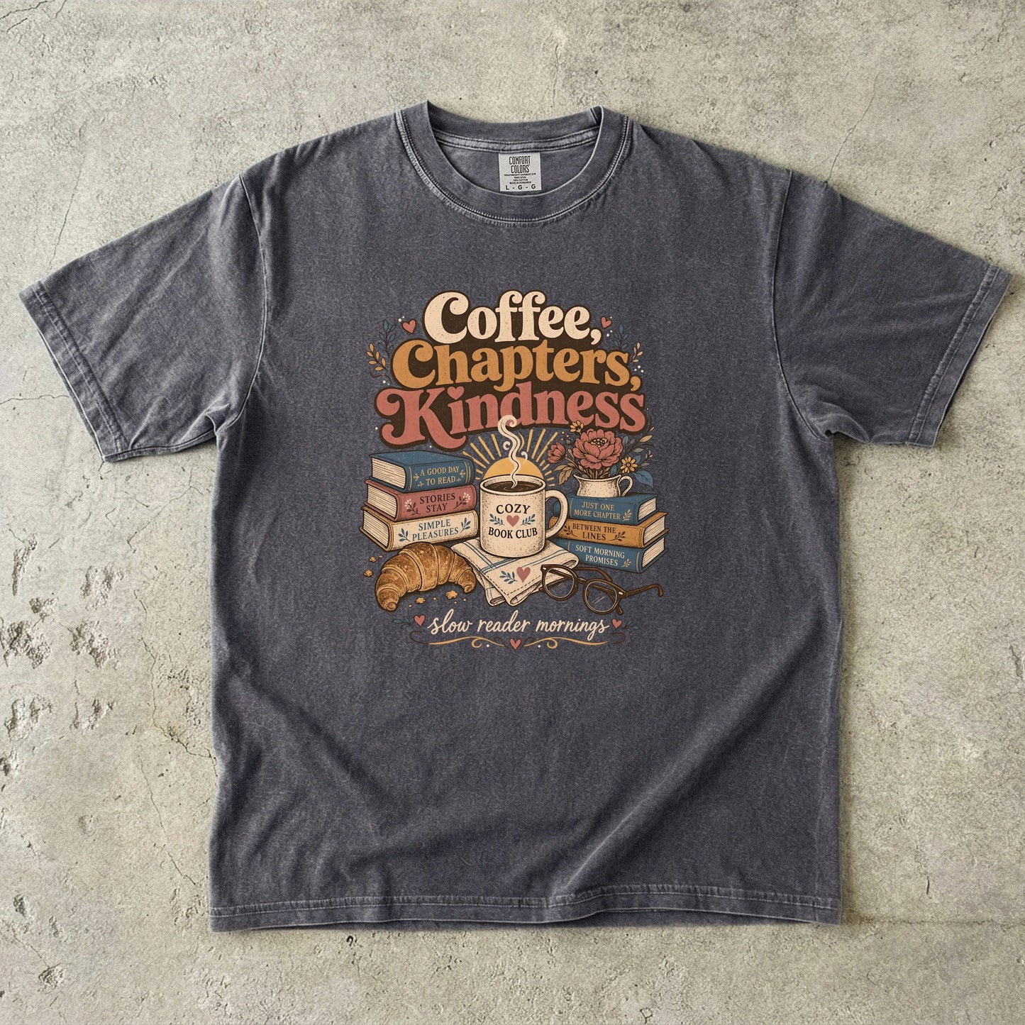 Coffee, Chapters, Kindness cozy reader T-shirt with coffee, books and croissant design on Pepper.