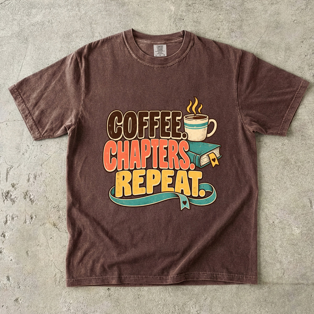 Espresso T-shirt featuring “Coffee. Chapters. Repeat.” with brown, coral and gold lettering, a steaming mug, a teal book and heart-shaped bookmark details.