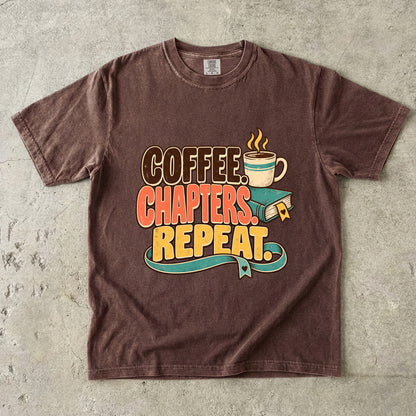 Espresso T-shirt featuring “Coffee. Chapters. Repeat.” with brown, coral and gold lettering, a steaming mug, a teal book and heart-shaped bookmark details.