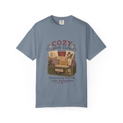 Cozy Book Club T-shirt in Blue Jean featuring a vintage story collection with classic books, flowers and reading notes