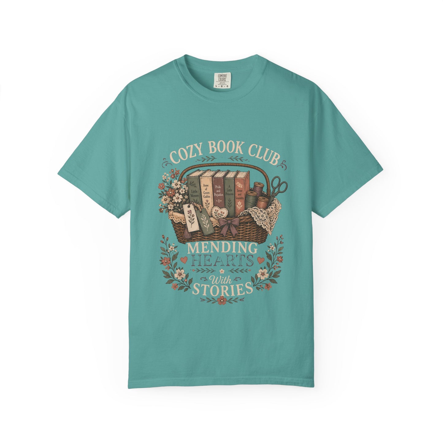 Cozy Book Club – Mending Hearts With Stories design printed on a Bay Comfort Colors 1717 T-shirt featuring a vintage basket of classic novels and floral accents.

