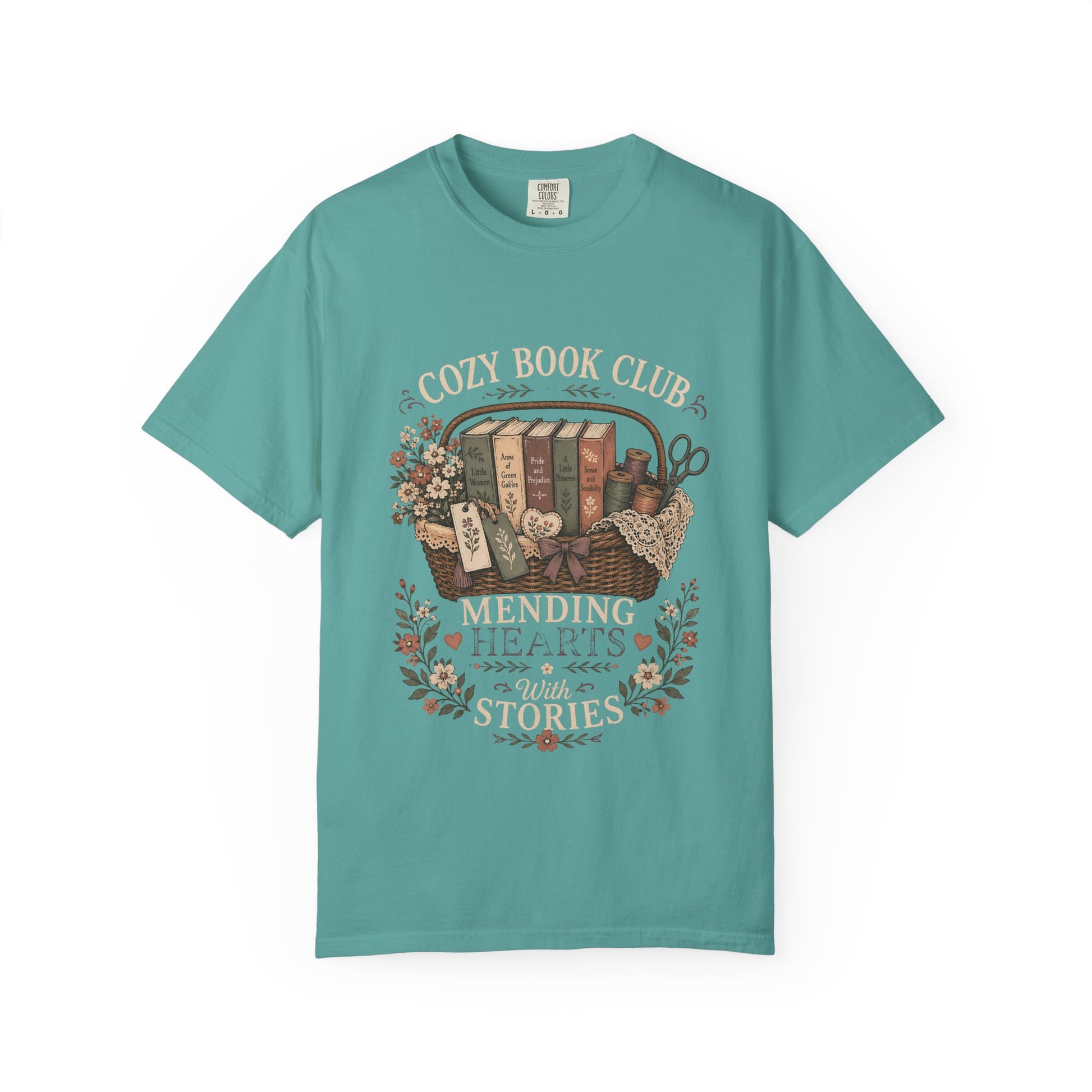 Cozy Book Club – Mending Hearts With Stories design printed on a Bay Comfort Colors 1717 T-shirt featuring a vintage basket of classic novels and floral accents.

