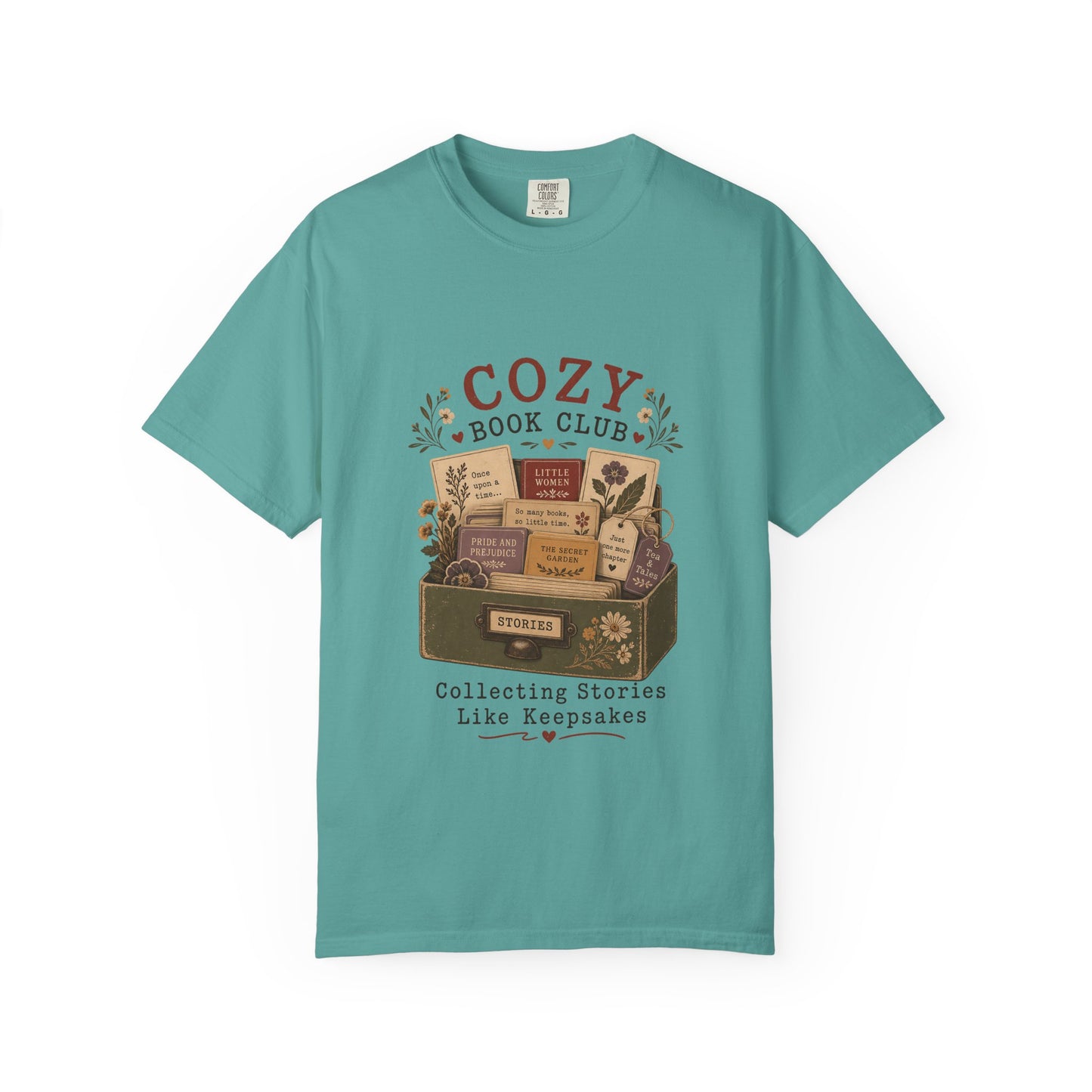 Front view of the Cozy Book Club Comfort Colors T-shirt in Seafoam featuring a vintage literary illustration with books, flowers and book club typography.
.