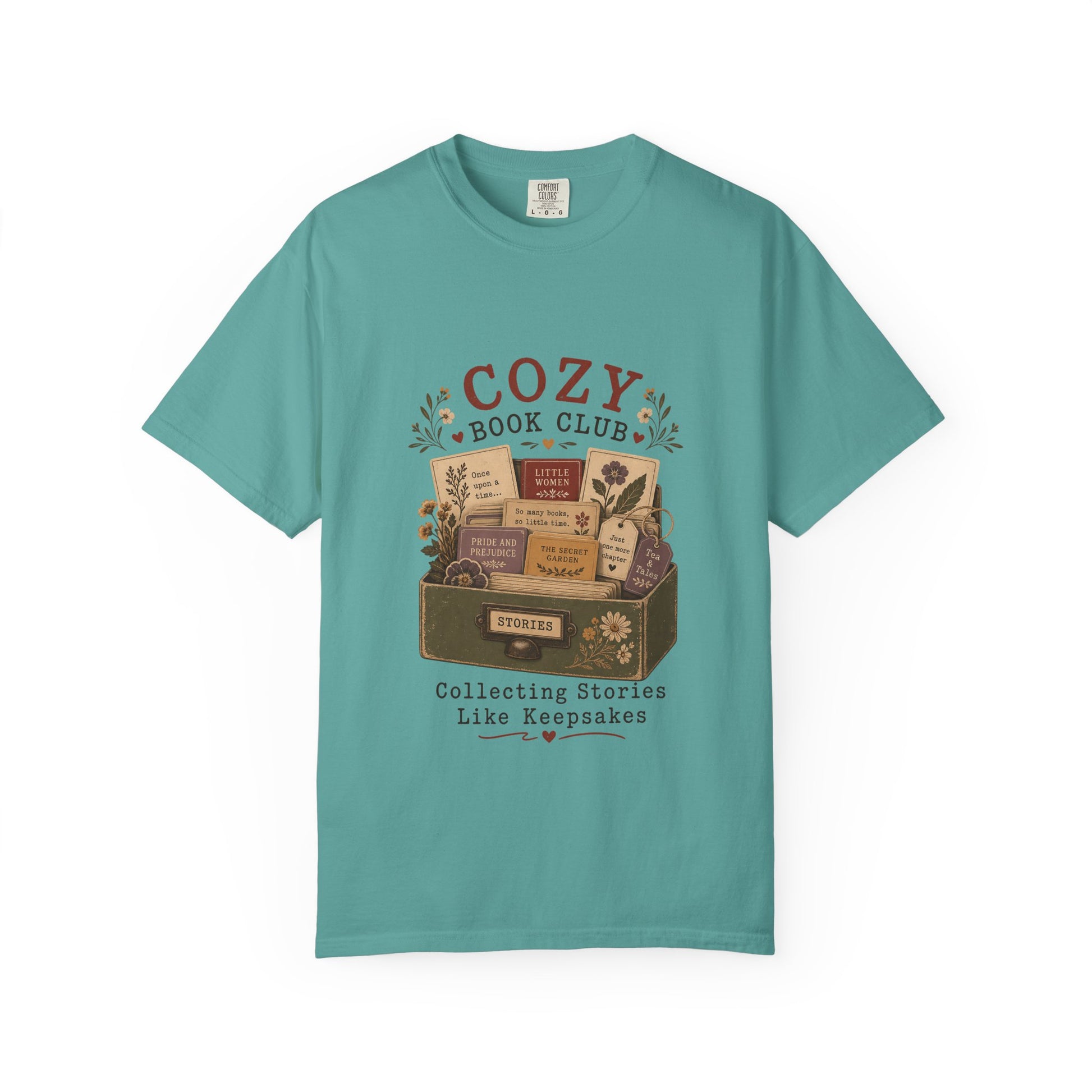 Front view of the Cozy Book Club Comfort Colors T-shirt in Seafoam featuring a vintage literary illustration with books, flowers and book club typography.
.