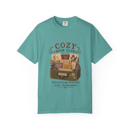 Front view of the Cozy Book Club Comfort Colors T-shirt in Seafoam featuring a vintage literary illustration with books, flowers and book club typography.
.