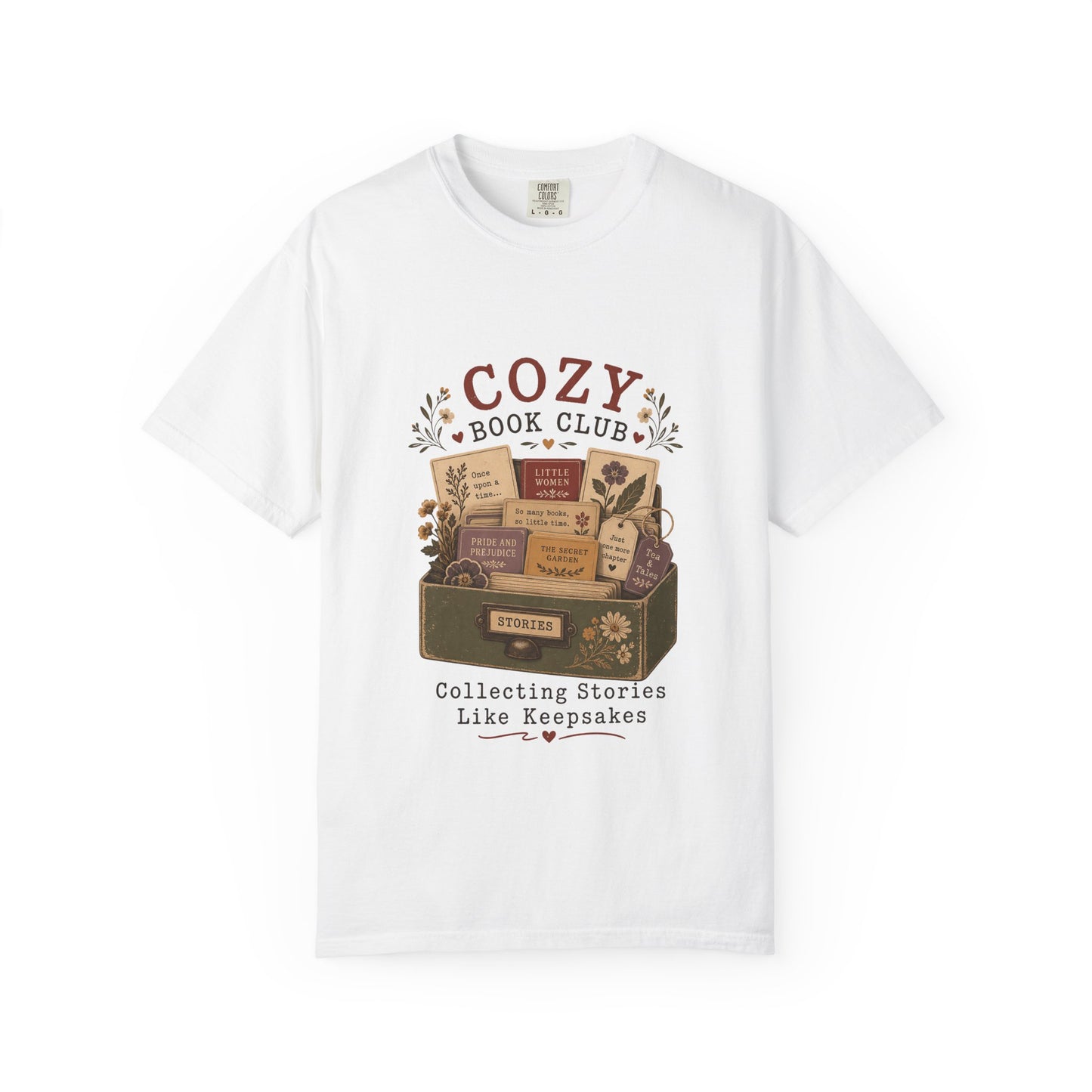 Front view of the Cozy Book Club Comfort Colors T-shirt in White featuring a vintage library drawer illustration with classic books and botanical details.