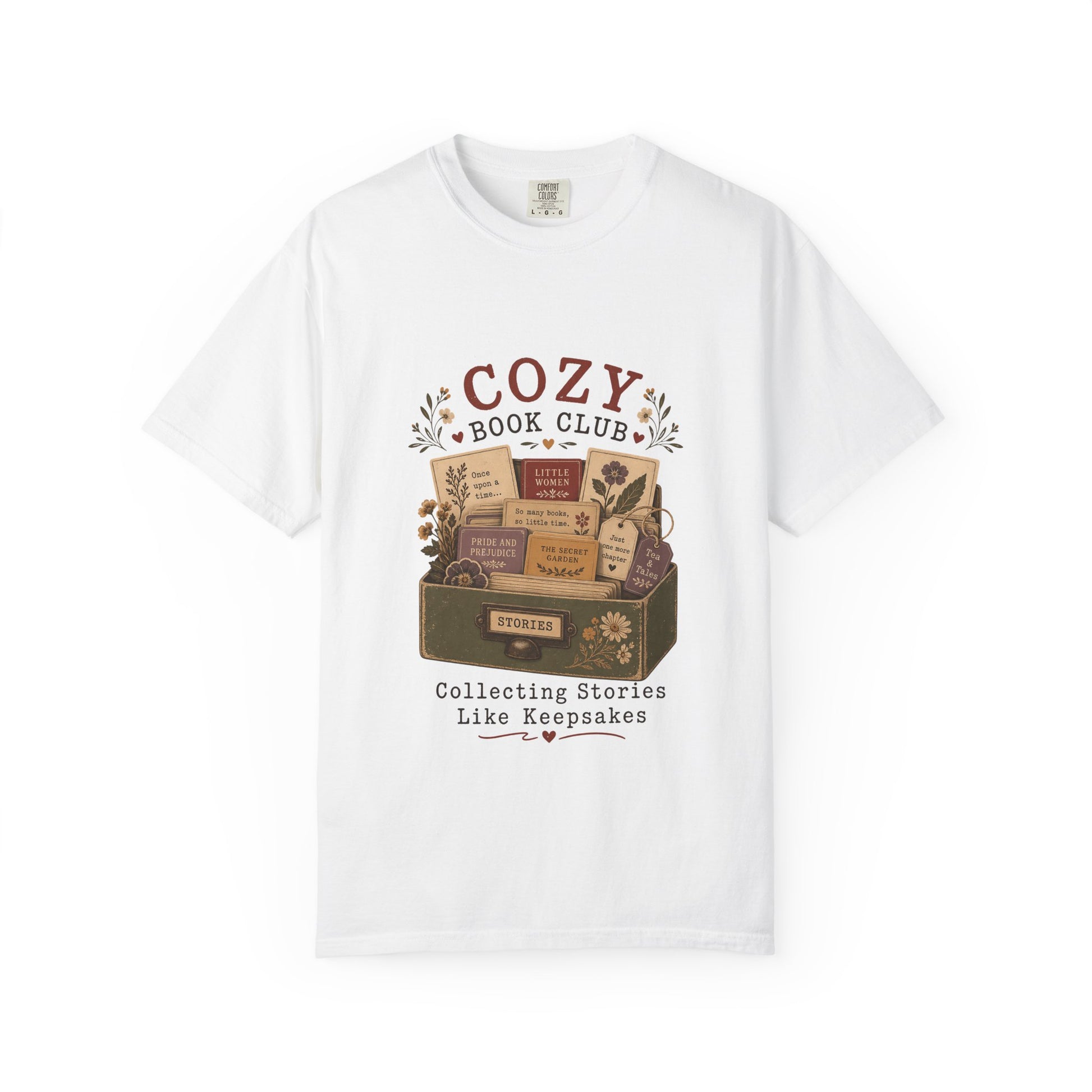 Front view of the Cozy Book Club Comfort Colors T-shirt in White featuring a vintage library drawer illustration with classic books and botanical details.