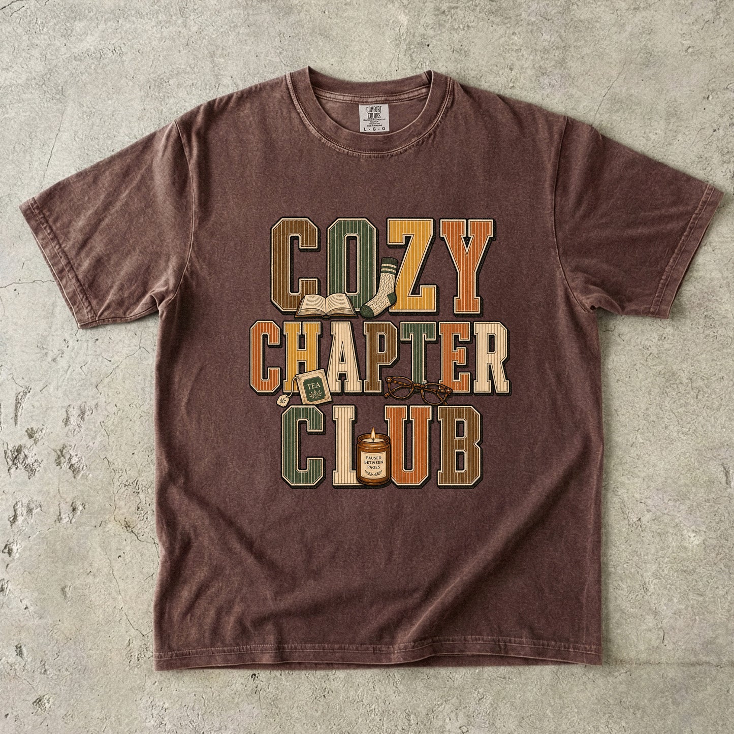Espresso Comfort Colors Cozy Chapter Club book lover T-shirt with vintage collegiate lettering and cozy reading details.