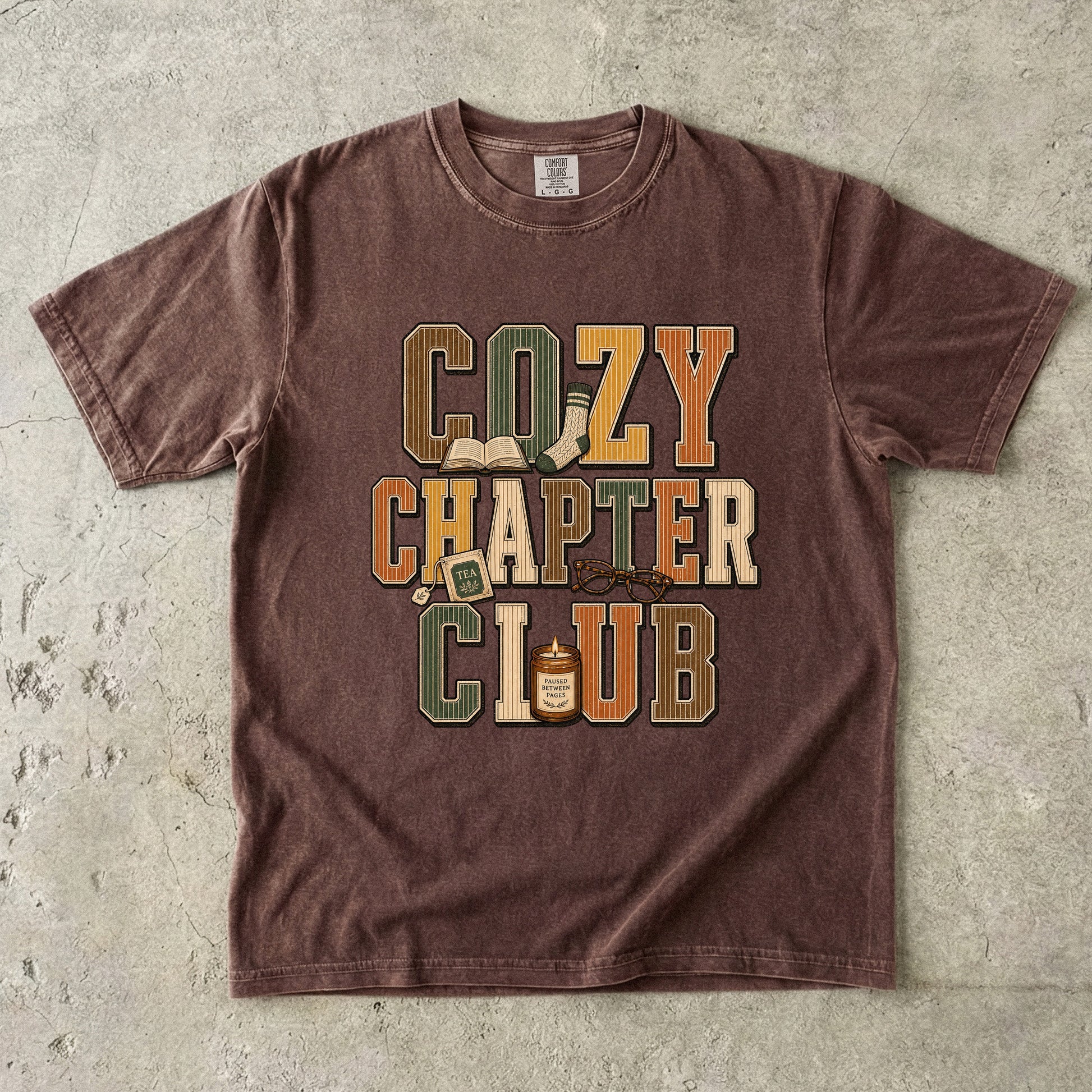 Espresso Comfort Colors Cozy Chapter Club book lover T-shirt with vintage collegiate lettering and cozy reading details.