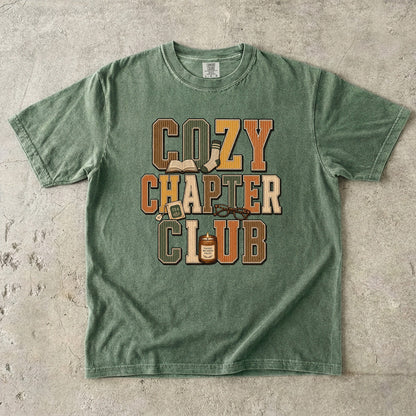 Moss Comfort Colors Cozy Chapter Club bookish T-shirt with warm vintage typography and reading-inspired details.