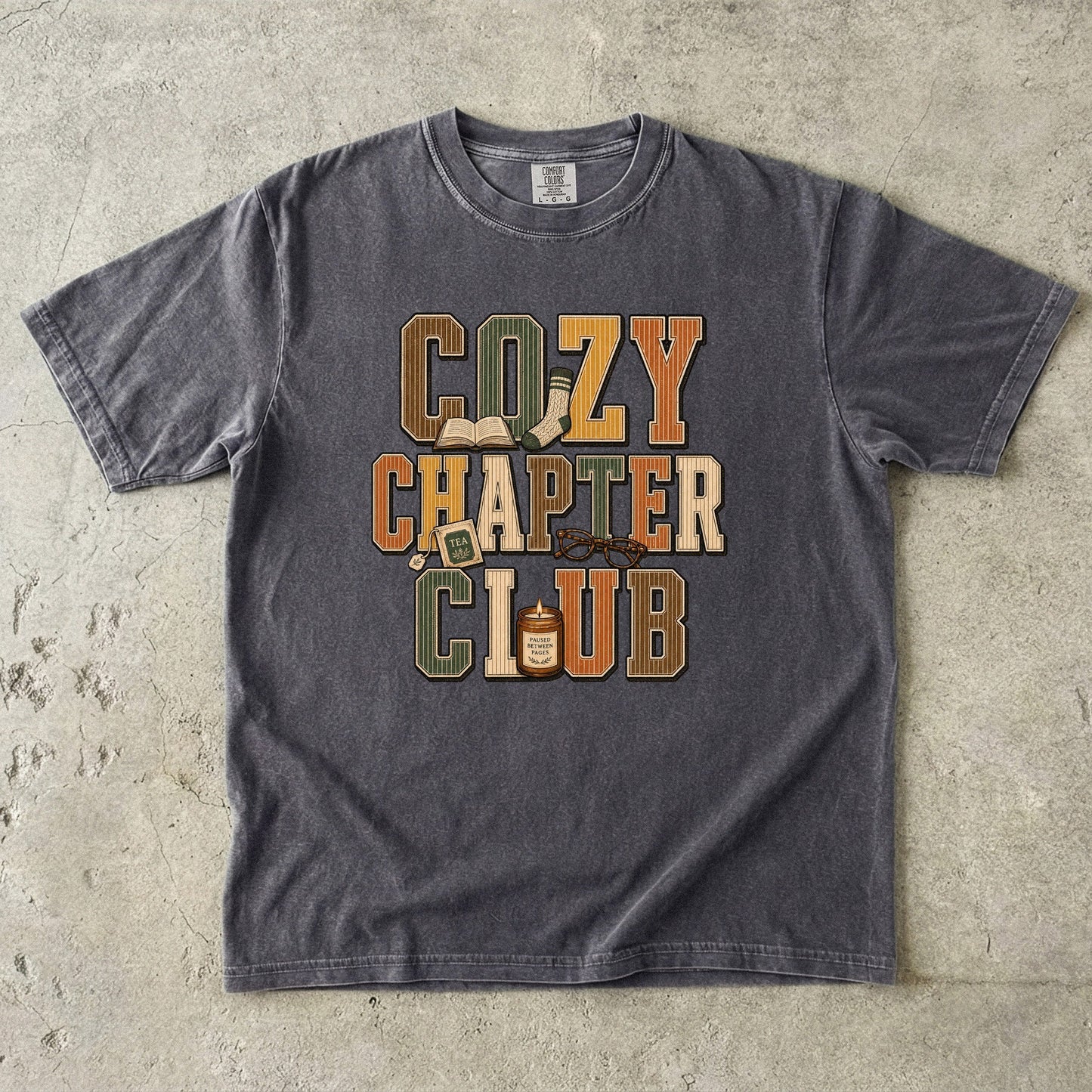 Pepper Comfort Colors Cozy Chapter Club book lover T-shirt featuring vintage collegiate lettering and cozy reading motifs.