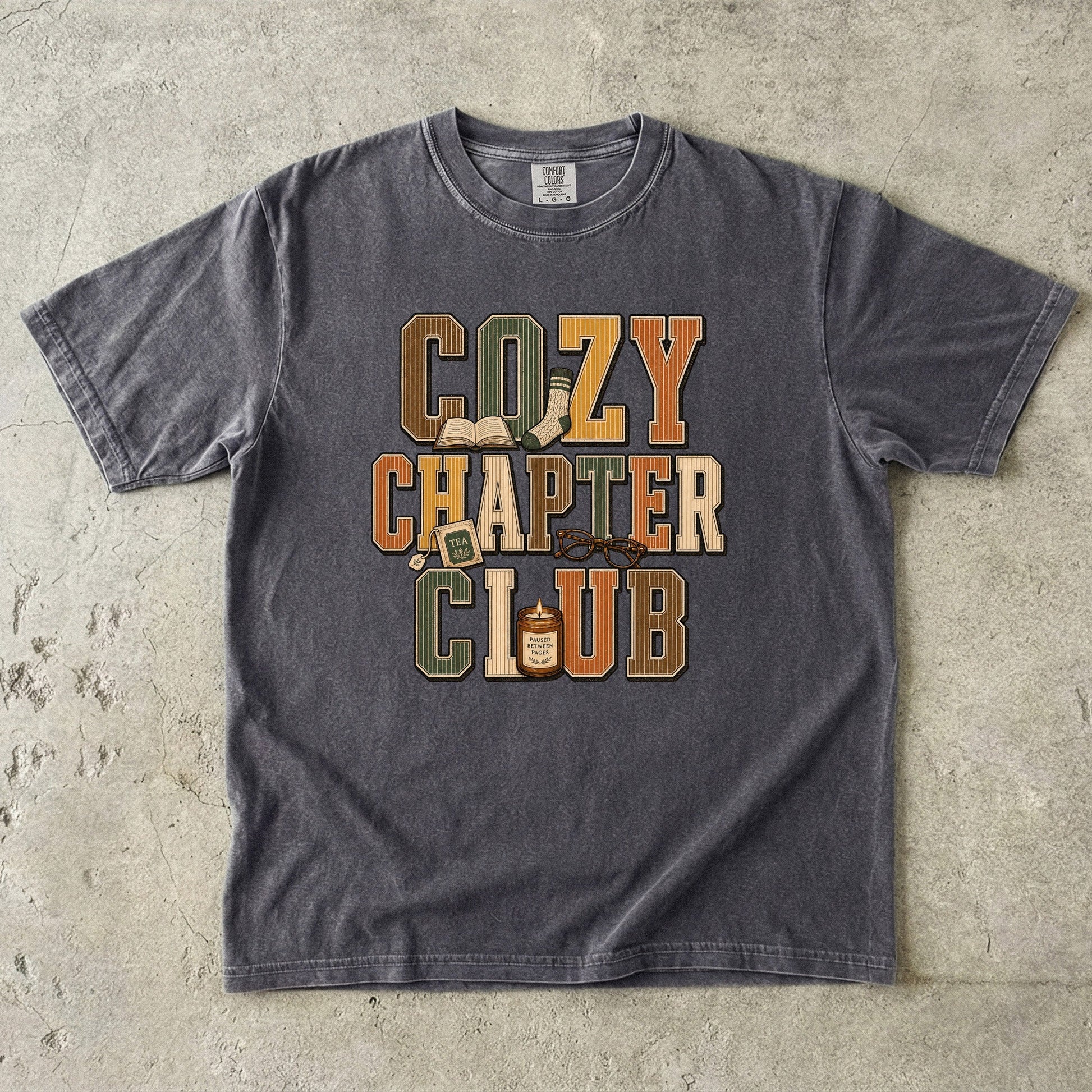 Pepper Comfort Colors Cozy Chapter Club book lover T-shirt featuring vintage collegiate lettering and cozy reading motifs.