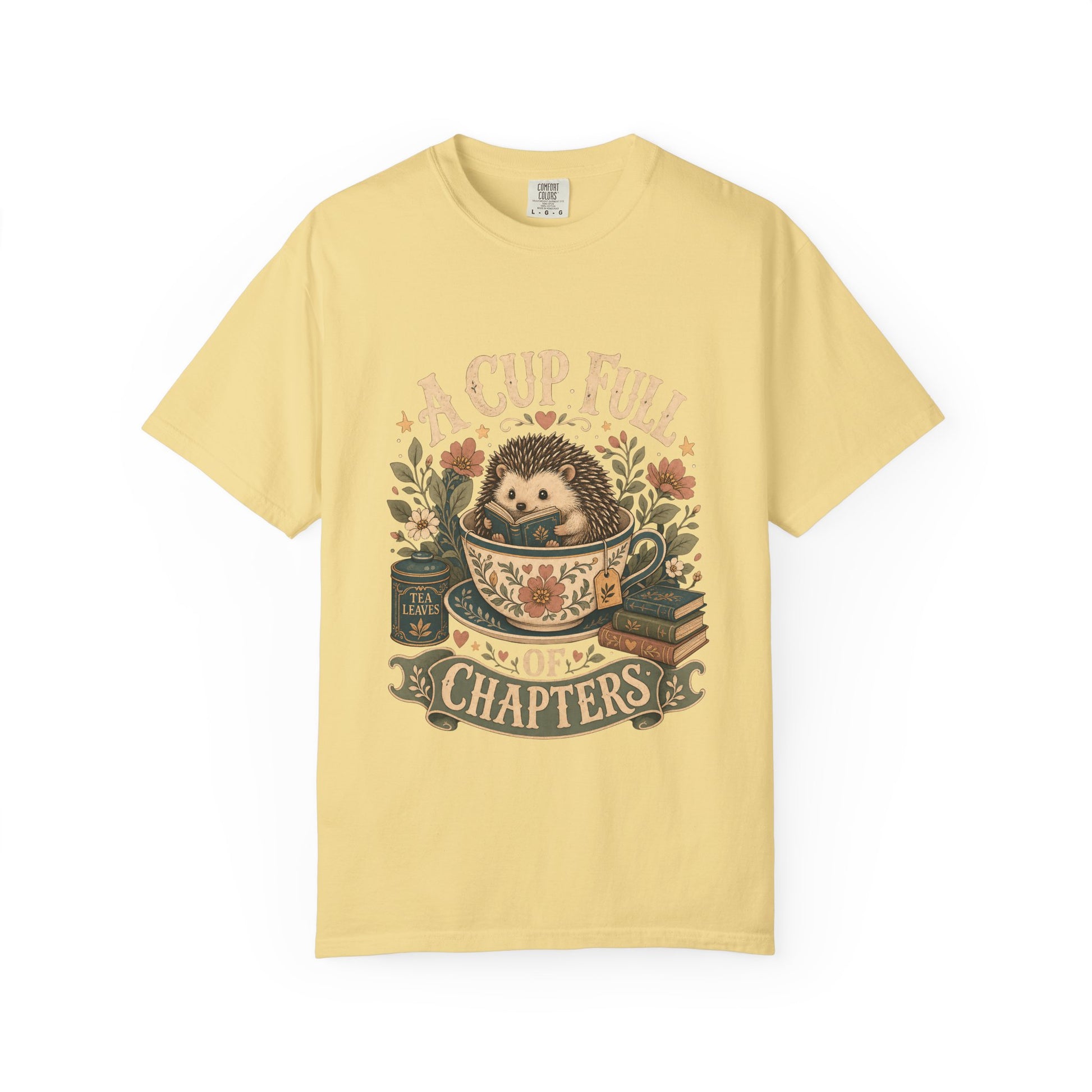 A Cup Full of Chapters hedgehog reading T-shirt in Butter featuring a hedgehog reading inside a floral teacup with books