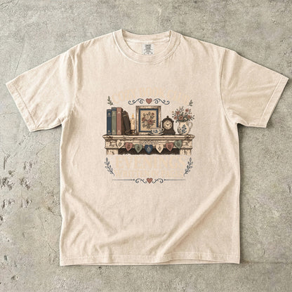 Evenings Written in Pages cozy book club T-shirt in Ivory featuring books, a candle, floral teacup, flowers and vintage mantel