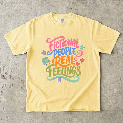 Butter Comfort Colors book lover shirt featuring colourful Fictional People, Real Feelings typography and bookish details.