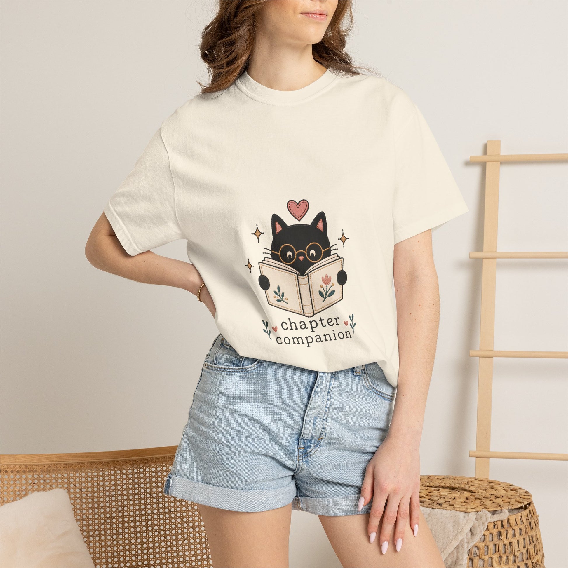 Woman wearing the ivory Chapter Companion vintage book lover cat T-shirt by Flourish Creation Labs, designed for readers and cosy reading days.