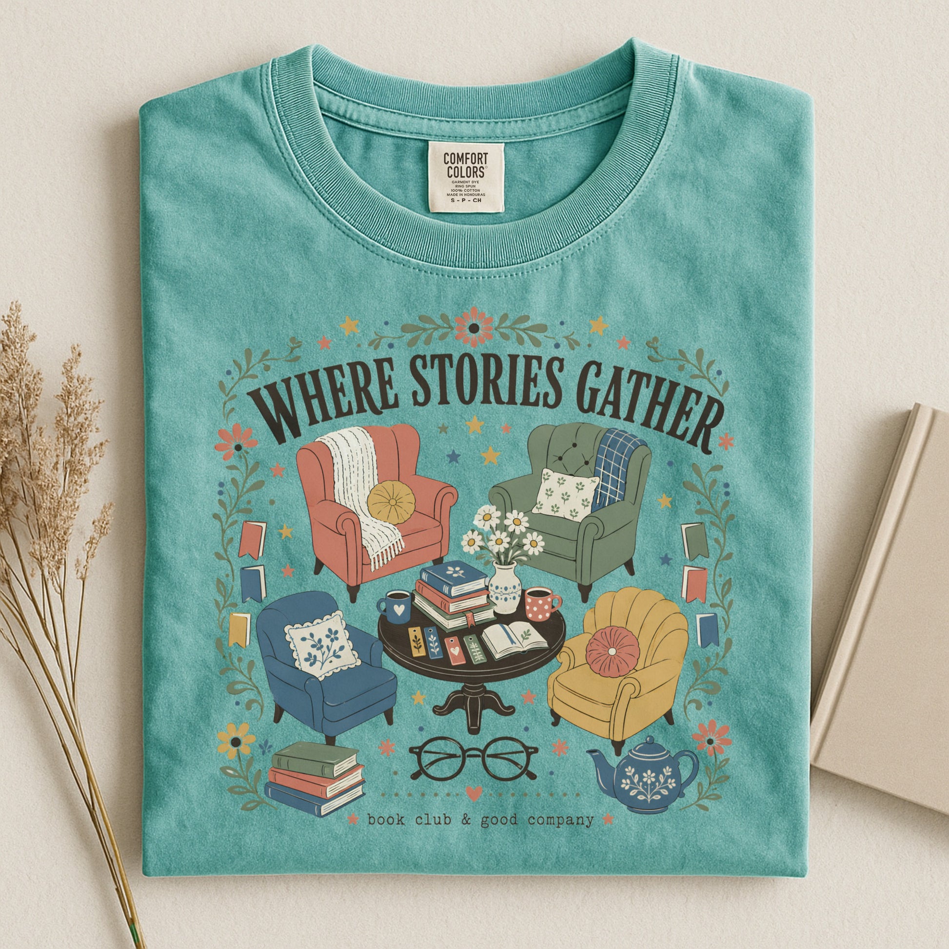 Folded seafoam Where Stories Gather literary graphic T-shirt inspired by books, libraries and cosy reading.