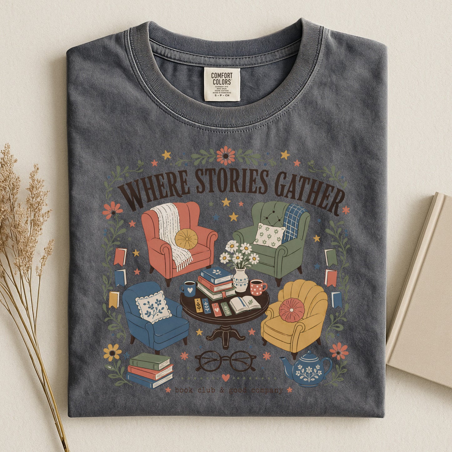 Folded pepper vintage reading T-shirt featuring the Where Stories Gather literary artwork by Flourish Creation Labs.