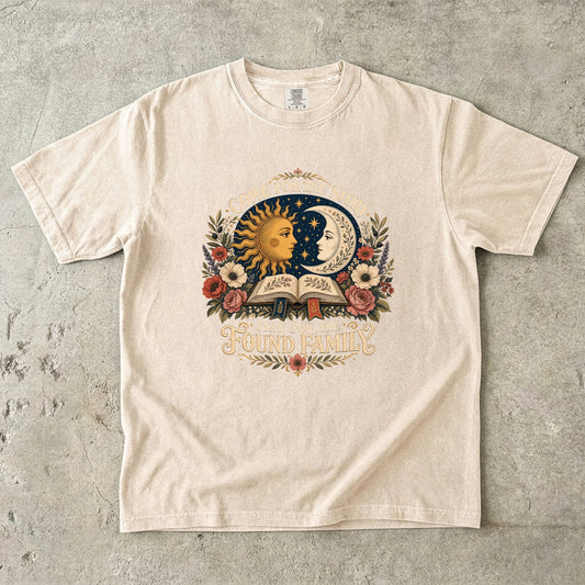 Ivory Comfort Colors book lover T-shirt featuring a floral celestial found family reading design.
