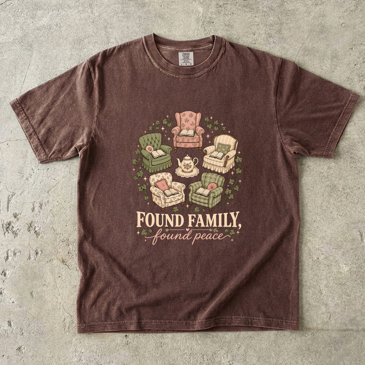 Espresso cozy reading T-shirt featuring Found Family, Found Peace with five vintage armchairs, open books, a floral teapot and ivy.