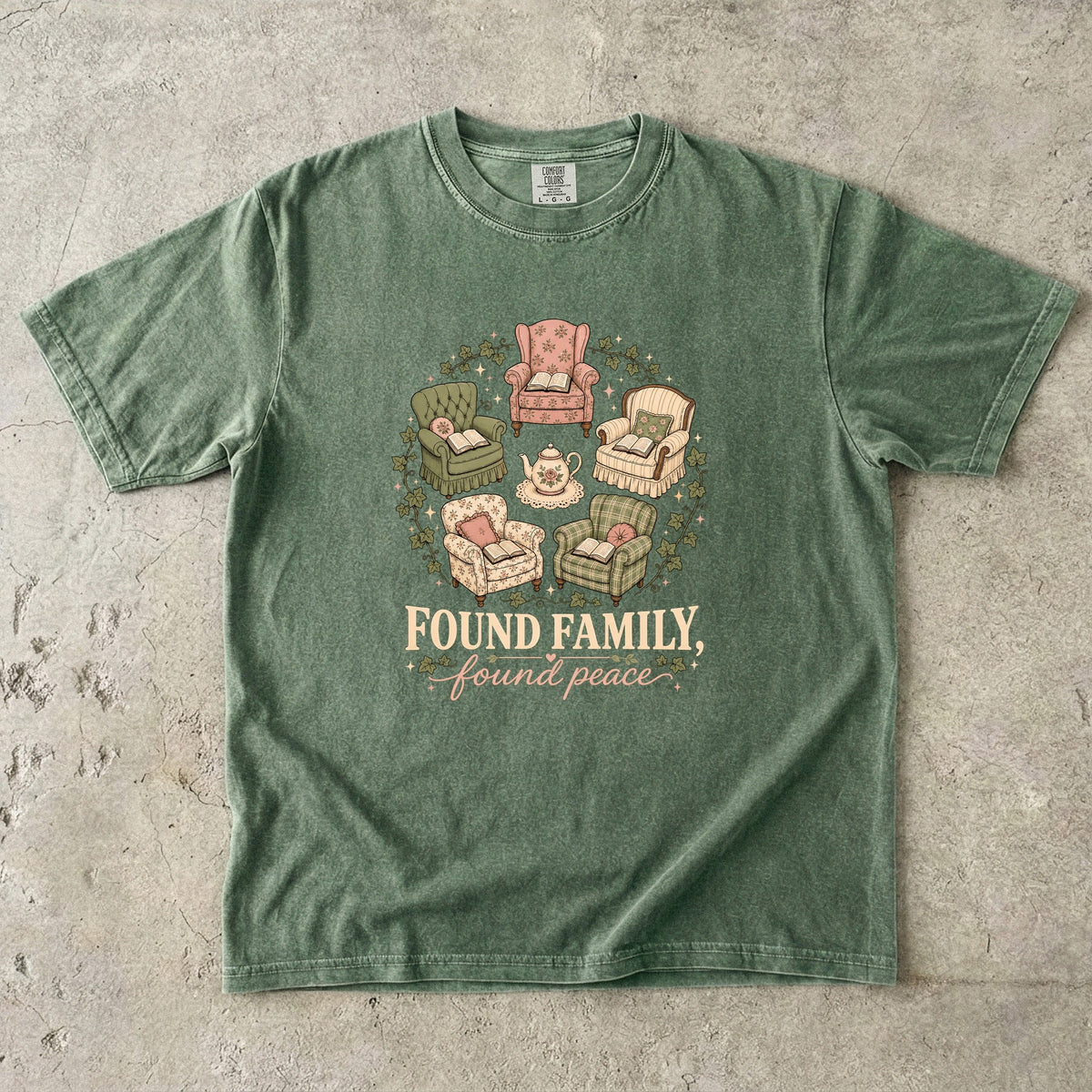 Moss cozy reading T-shirt featuring Found Family, Found Peace with five vintage armchairs, open books, a floral teapot and ivy.