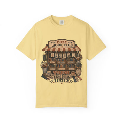 Fresh Stories Daily book club T-shirt in Butter featuring a vintage bookstall filled with books, flowers and reading themes